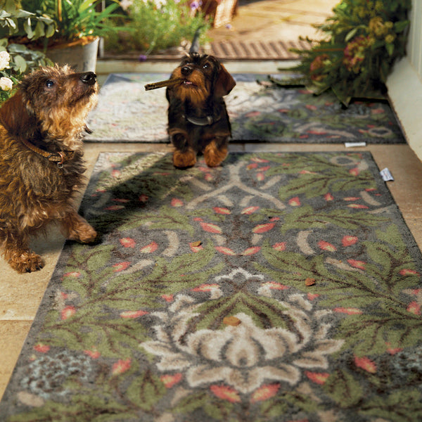 Nature 12 Washable Runner- a 100% recycled cotton runner featuring a motif of dark green leaves with hints of red, yellow, and blue flowers.