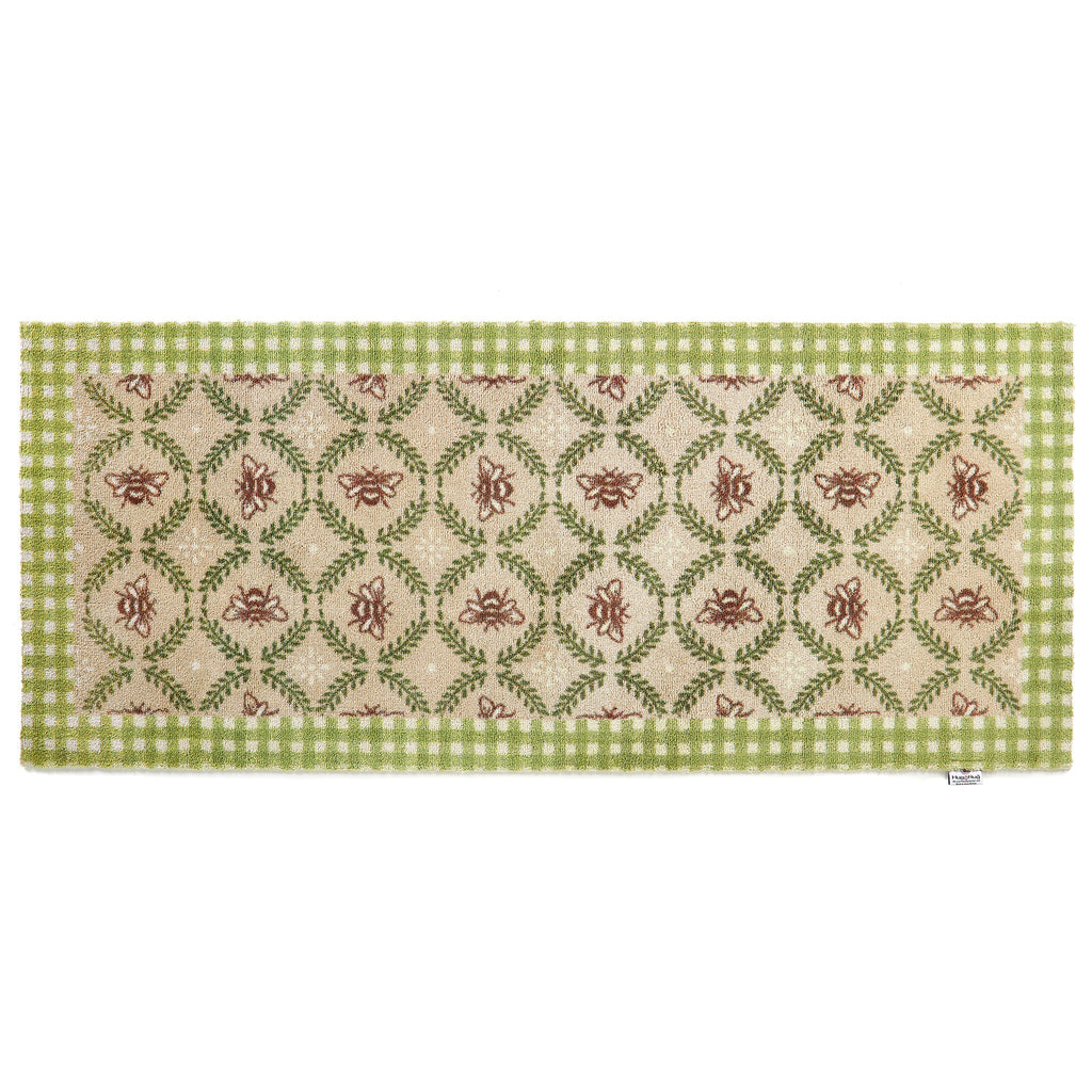 Beehive Green Charity Runner in Beige- a 100% recycled cotton runner featuring a white and green checked border and a collection of hand-painted bumblebees surrounded by a leafy garland.