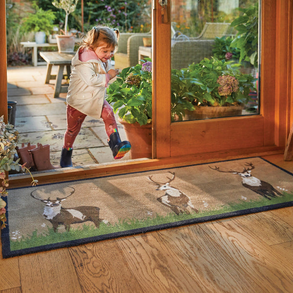 Deer 1 Beige Washable Runner in Beige- a 100% recycled cotton runner featuring three deers in short grass and flowers.