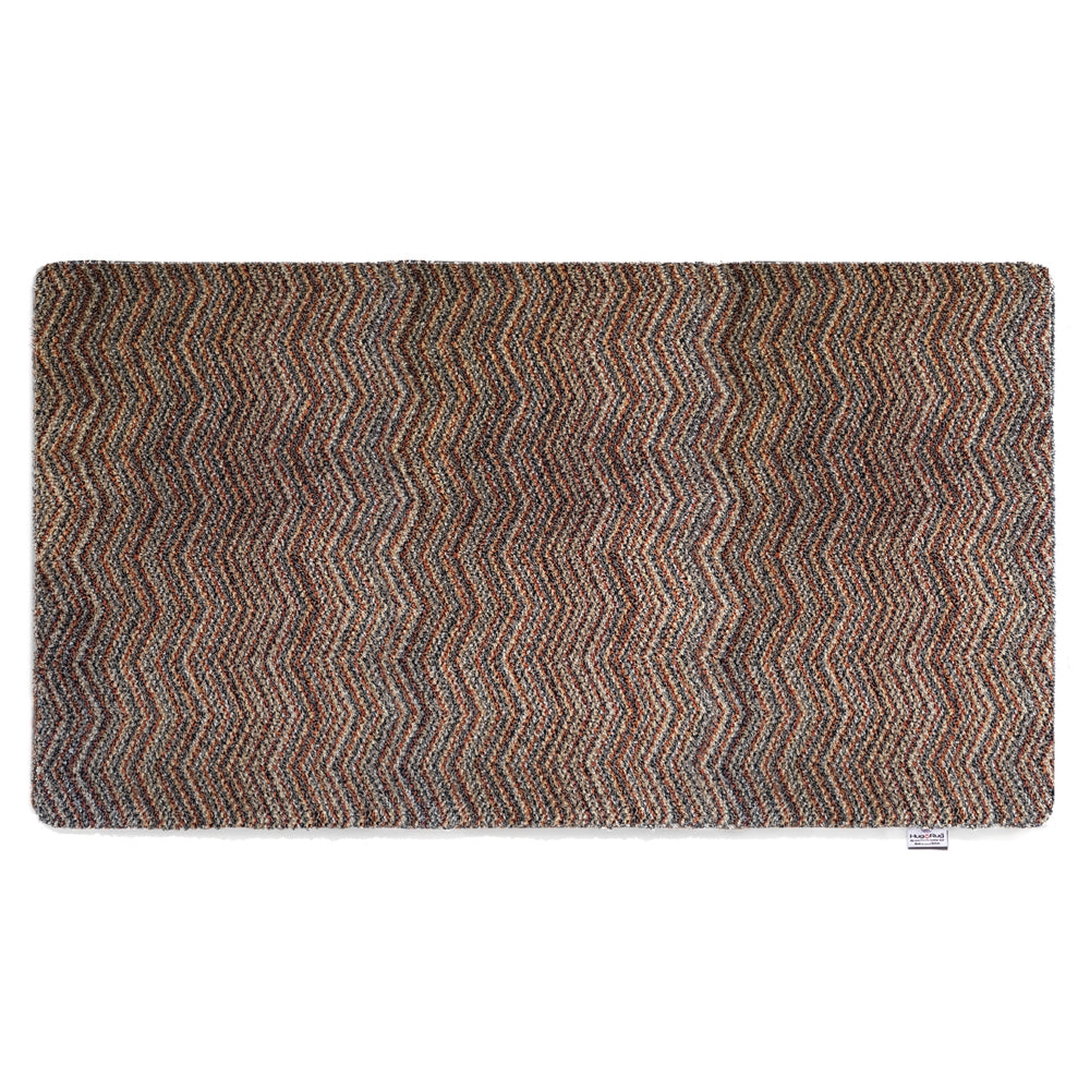 Candy Zig Zag Washable Runner- a 100% recycled material runner featuring a subtle zig-zag pattern in shades of red, beige, and navy, with a touch of white.