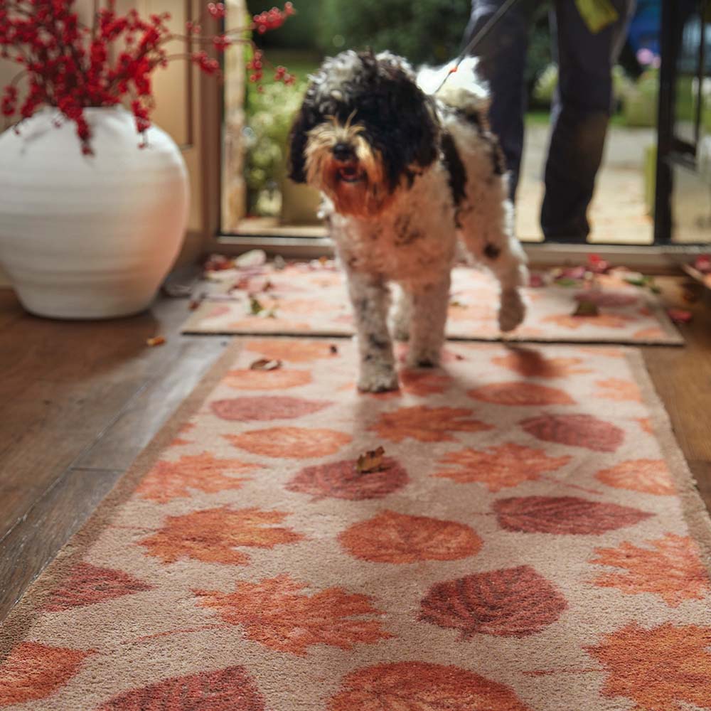 Autumn Leaves Washable Runner in Beige- a 100% recycled cotton runner featuring hand-painted leaves in various shades of orange, red, and brown.