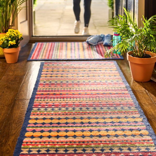 Beady Stripe Charity Runner- a 100% recycled cotton runner featuring multi-coloured stripe pattern in navy, red, pink, orange, green, white and beige.