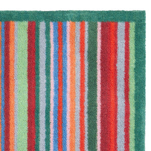 Bright Green Stripe Washable Runner- a 100% recycled cotton runner featuring a bright striped design in green, red, orange, and blue.