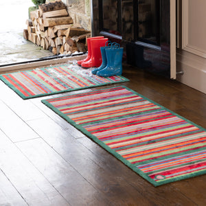 Bright Green Stripe Washable Runner- a 100% recycled cotton runner featuring a bright striped design in green, red, orange, and blue.