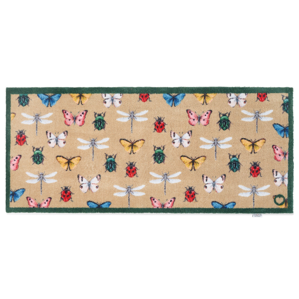 Bugs & Butterflies Beige Washable Runner in Beige- a 100% recycled cotton runner featuring a horizontal row of insects including butterflies, dragonflies, ladybugs, and beetles, in shades of blue, red, green, yellow, and white.