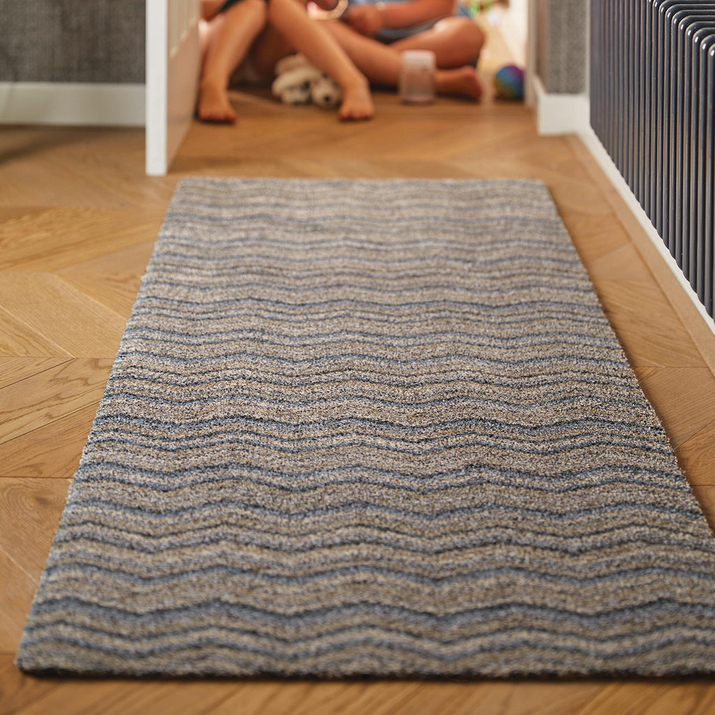 Ribbon Grey Zig Zag Washable Runner- a 100% recycled material runner featuring a subtle zig-zag pattern in shades of navy, blue, white, and beige.