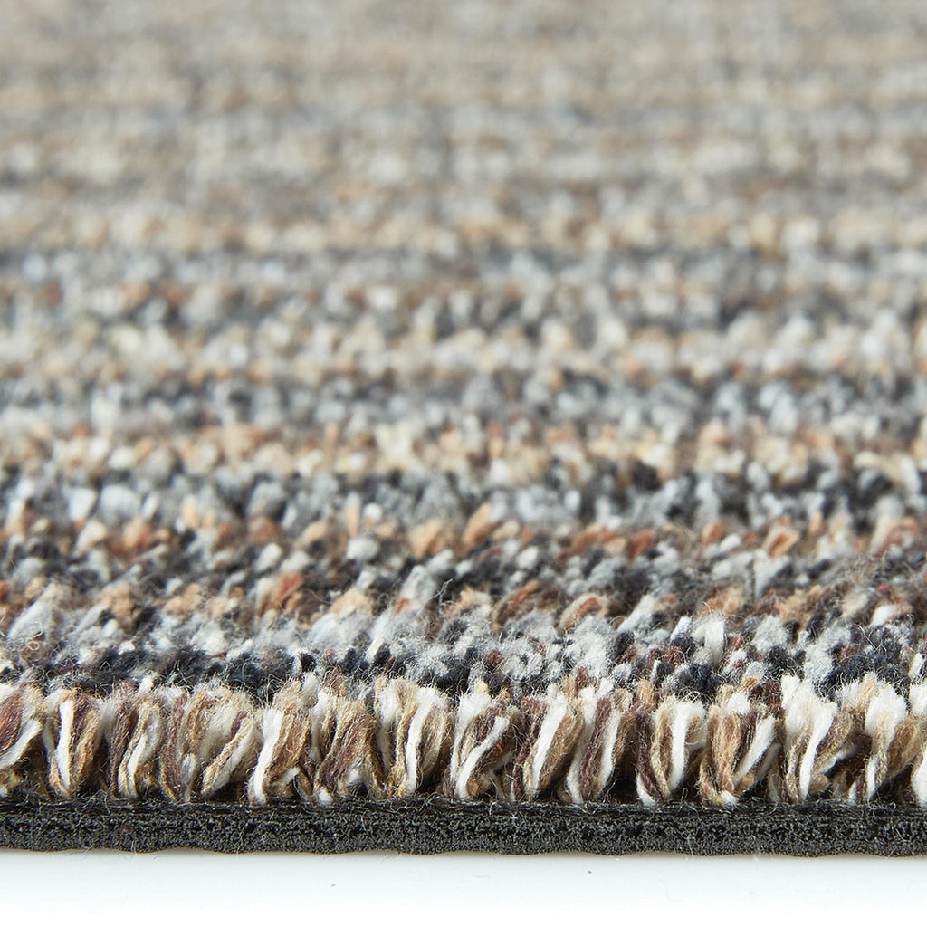 Candy Rocks Striped Washable Runner- a 100% recycled material runner featuring a subtle striped pattern in shades of beige, grey, and orange.