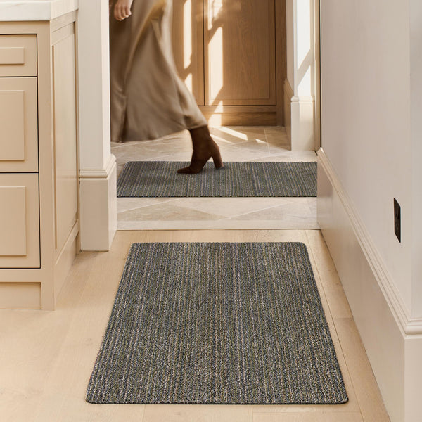 Candy Sage Green Washable Runner- a 100% recycled material runner featuring a subtle striped pattern in shades of grey, beige, and medium green.