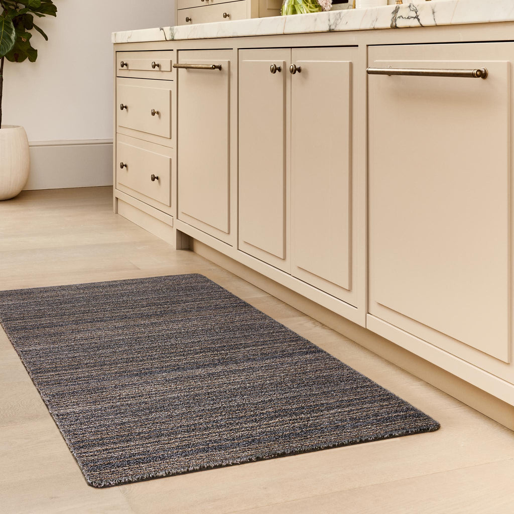 Candy Slate Striped Washable Runner- a 100% recycled material runner featuring a subtle striped pattern in shades of grey, beige, and brown.