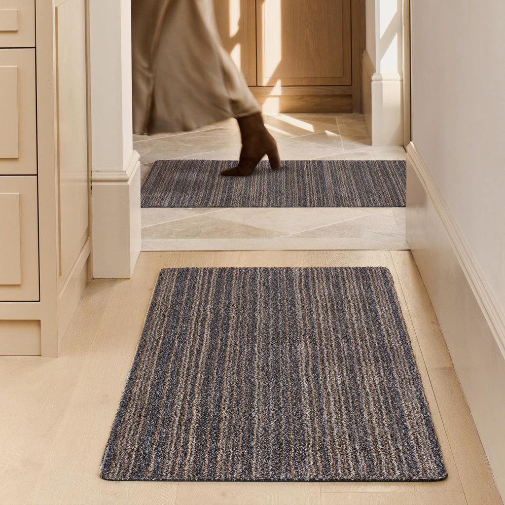Candy Slate Striped Washable Runner- a 100% recycled material runner featuring a subtle striped pattern in shades of grey, beige, and brown.