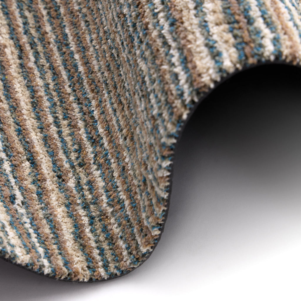 Candy Sand Striped Washable Runner- a 100% recycled material runner featuring a subtle striped pattern in shades of teal, beige, brown, white, and light grey.