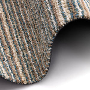 Candy Sand Striped Washable Runner- a 100% recycled material runner featuring a subtle striped pattern in shades of teal, beige, brown, white, and light grey.