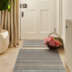 Candy Sand Stripe Washable Doormat- a recycled material doormat with a fleck design in the shades of teal, beige, brown, white, and light grey.