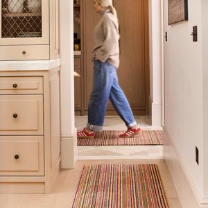 Candy Bright Stripe Washable Runner- a 100% recycled material runner featuring a striped pattern in shades of orange, red, beige, and grey.