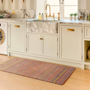 Candy Bright Stripe Washable Runner- a 100% recycled material runner featuring a striped pattern in shades of orange, red, beige, and grey.