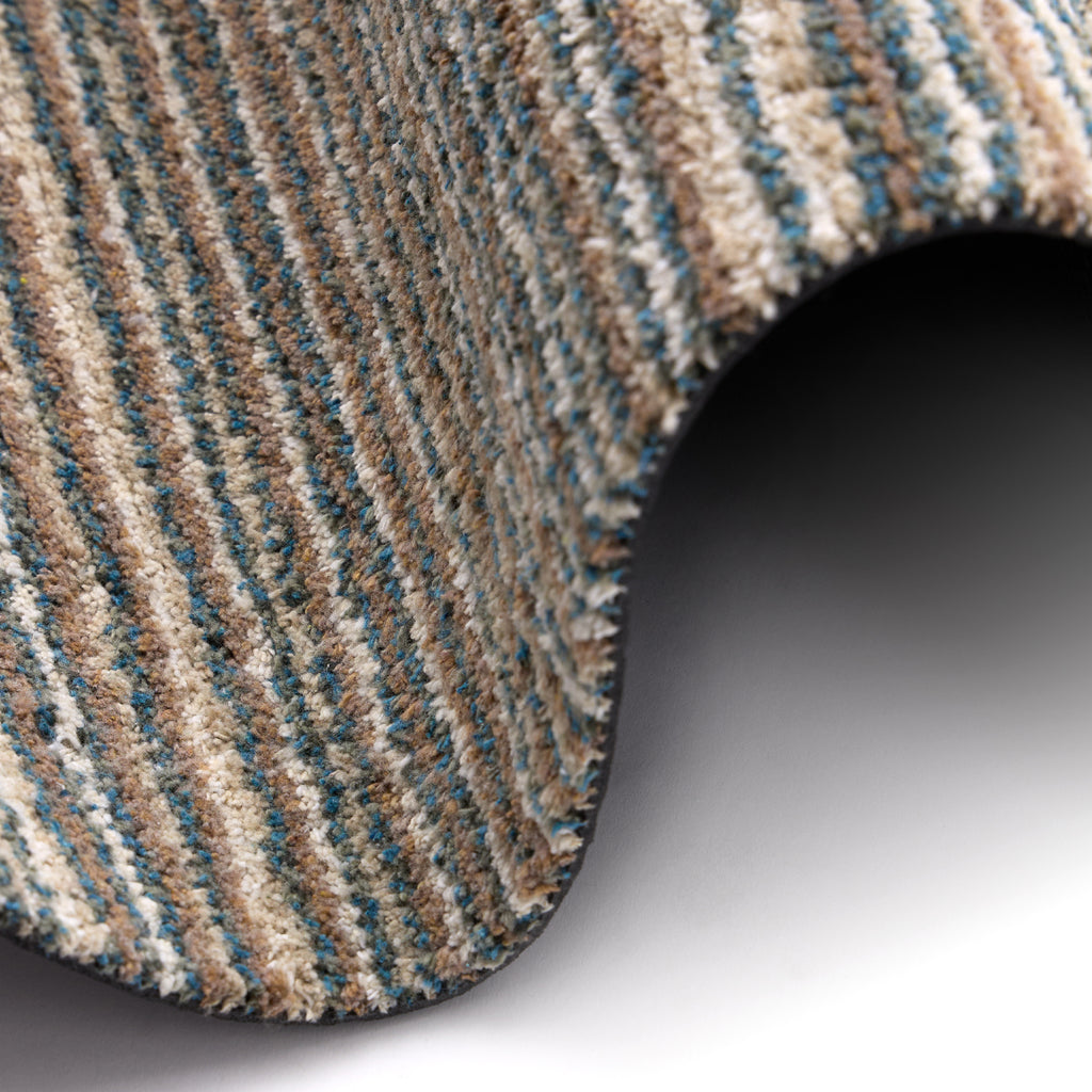 Candy Sand Stripe Washable Doormat- a recycled material doormat with a fleck design in the shades of teal, beige, brown, white, and light grey.