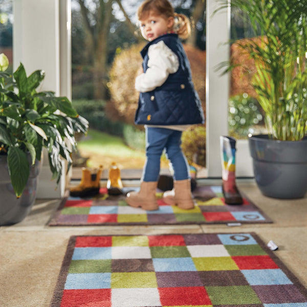 Check 10 Washable Runner- a 100% recycled cotton runner featuring multicoloured square checks in red, blue, white, and plum.