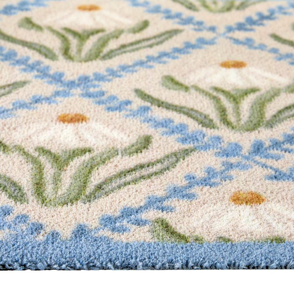 Daisy Trellis Washable Runner- a 100% recycled cotton runner featuring a daisy motif arranged within a trellis of blue, vine-like lines.