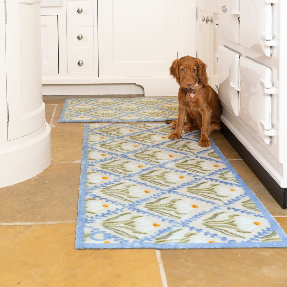 Daisy Trellis Washable Runner- a 100% recycled cotton runner featuring a daisy motif arranged within a trellis of blue, vine-like lines.