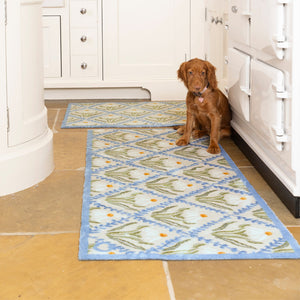 Daisy Trellis Washable Runner- a 100% recycled cotton runner featuring a daisy motif arranged within a trellis of blue, vine-like lines.