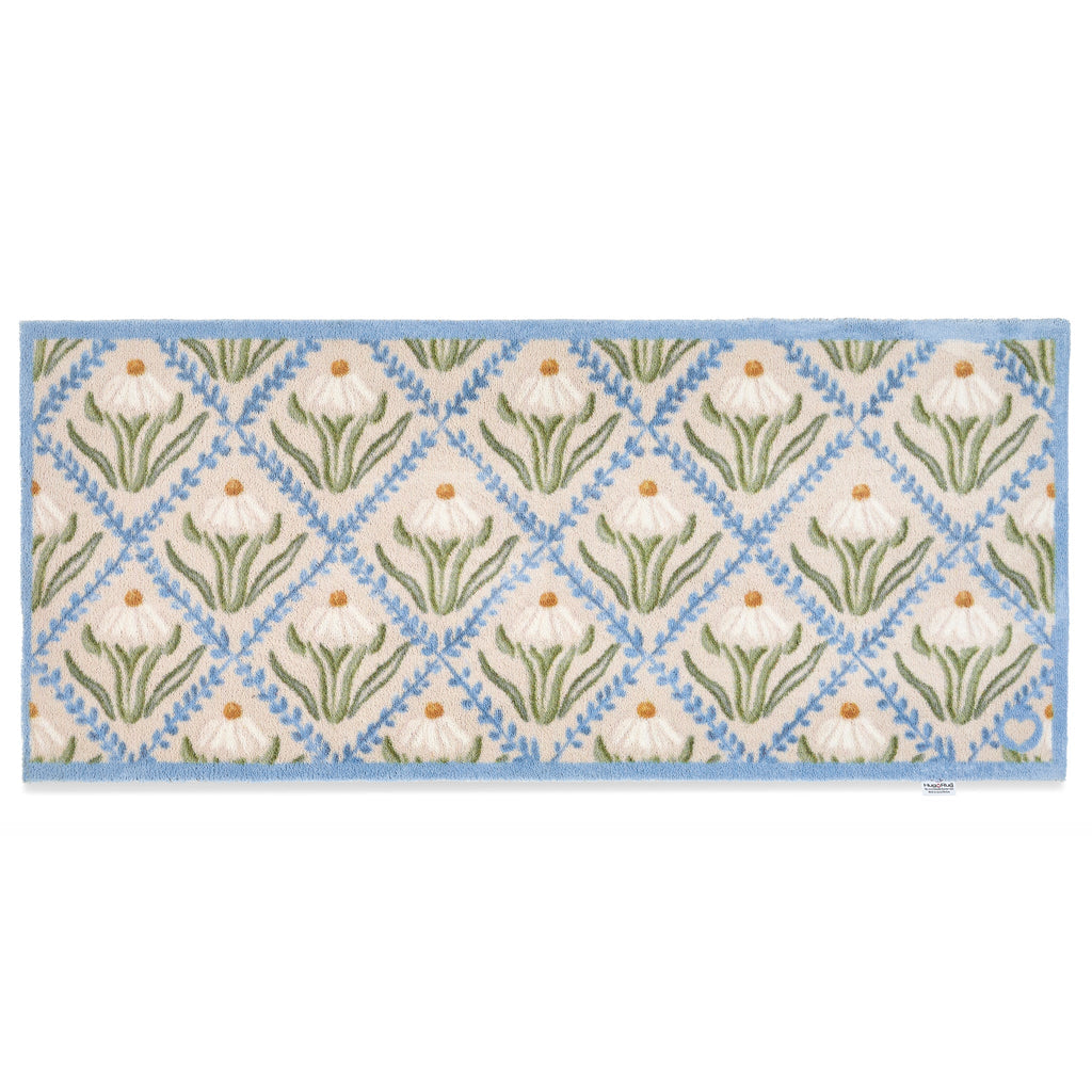 Daisy Trellis Washable Runner- a 100% recycled cotton runner featuring a daisy motif arranged within a trellis of blue, vine-like lines.