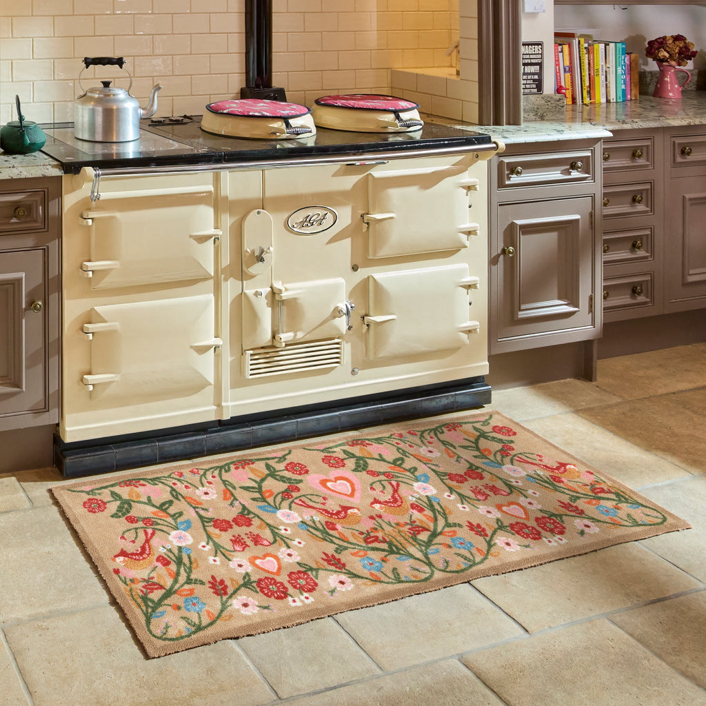 Garden Lovebirds Washable Runner- a 100% recycled cotton doormat featuring two lovebirds in shades of red, yellow, light pink, and cream, surrounded by floral vines.