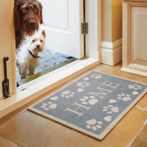 Home Paws Blue Doormat- a cotton mat with a light blue background with white paw prints and love hearts. Featuring Home Written in the centre of the mat.