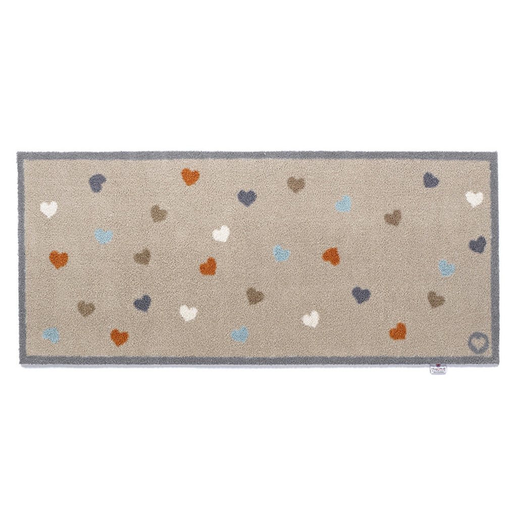 Home 34 Washable Runner in beige- a 100% recycled cotton runner featuring multicoloured hearts scattered across the runner.