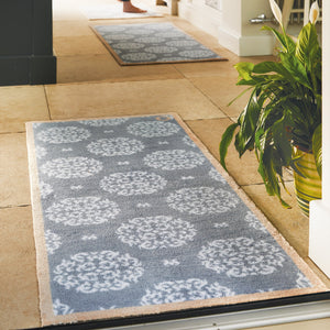 Home 44 Washable Runner in Grey- a 100% recycled cotton runner featuring a horizontal array of white floral patterns.