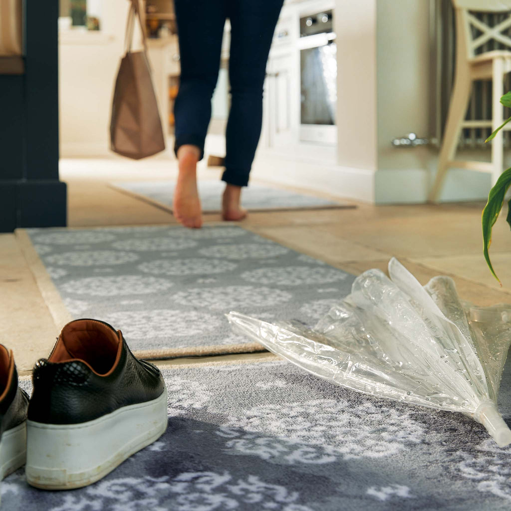 Home 44 Washable Runner in Grey- a 100% recycled cotton runner featuring a horizontal array of white floral patterns.