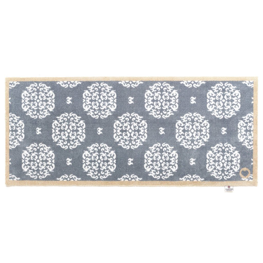 Home 44 Washable Runner in Grey- a 100% recycled cotton runner featuring a horizontal array of white floral patterns.