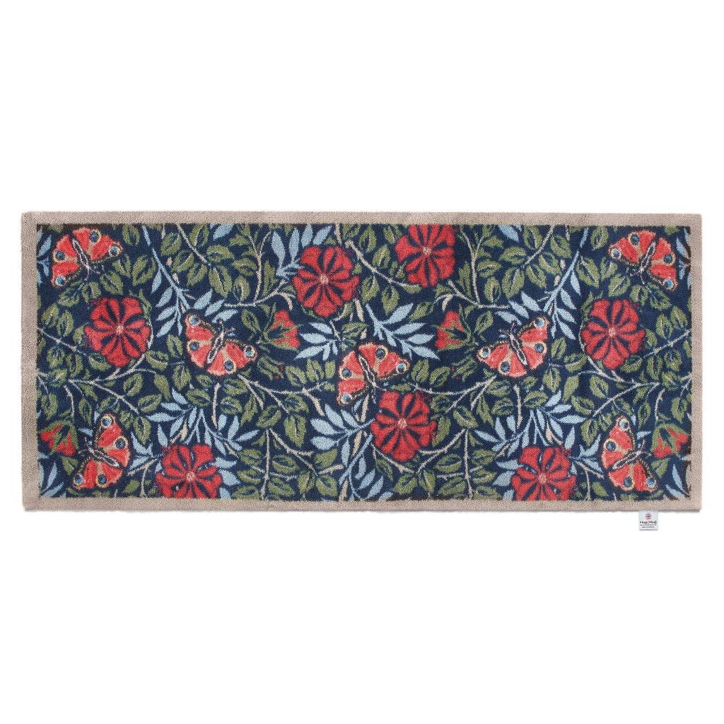 Nature 29 Washable Runner- a 100% recycled cotton runner featuring red flowers and butterflies surrounded by green and blue leaves.