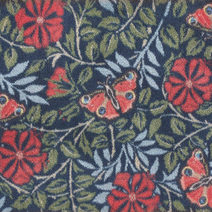 Nature 29 Washable Runner- a 100% recycled cotton runner featuring red flowers and butterflies surrounded by green and blue leaves.