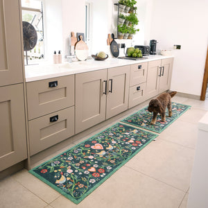 Nature 35 Love Birds Washable Runner in a dark blue- a 100% recycled cotton runner featuring a symmetrical pattern of intertwined branches adorned with colourful leaves and flowers.