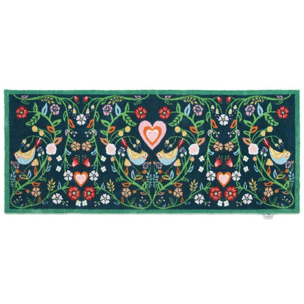 Nature 35 Love Birds Washable Runner in a dark blue- a 100% recycled cotton runner featuring a symmetrical pattern of intertwined branches adorned with colourful leaves and flowers.