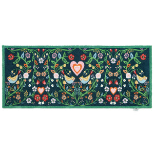 Nature 35 Love Birds Washable Runner in a dark blue- a 100% recycled cotton runner featuring a symmetrical pattern of intertwined branches adorned with colourful leaves and flowers.