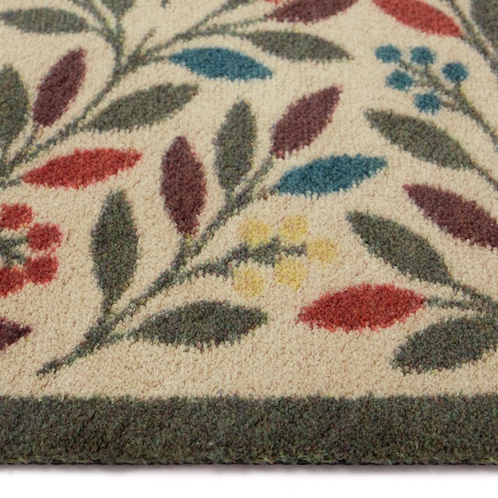 Olive Branch Washable Runner in a light brown- a 100% recycled cotton runner featuring branches adorned with multicoloured leaves and olives.