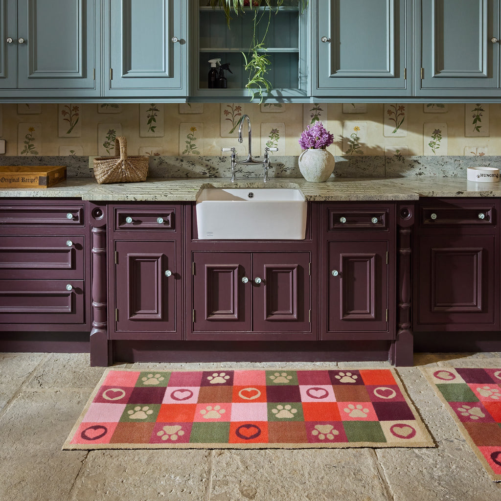 Patchwork Paws Washable Runner- a 100% recycled cotton runner featuring colourful squares decorated with paw prints and hearts in shades of red, purple, pink, green, and brown.