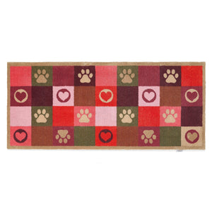 Patchwork Paws Washable Runner- a 100% recycled cotton runner featuring colourful squares decorated with paw prints and hearts in shades of red, purple, pink, green, and brown.
