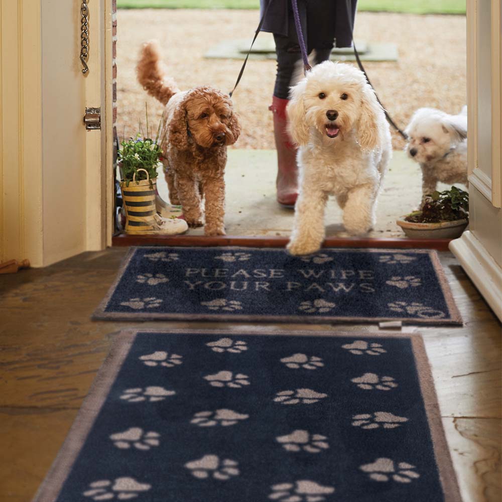 Pet 10 Navy Washable Runner in Blue- a 100% recycled cotton runner featuring beige paw prints in a multi-directional pattern.