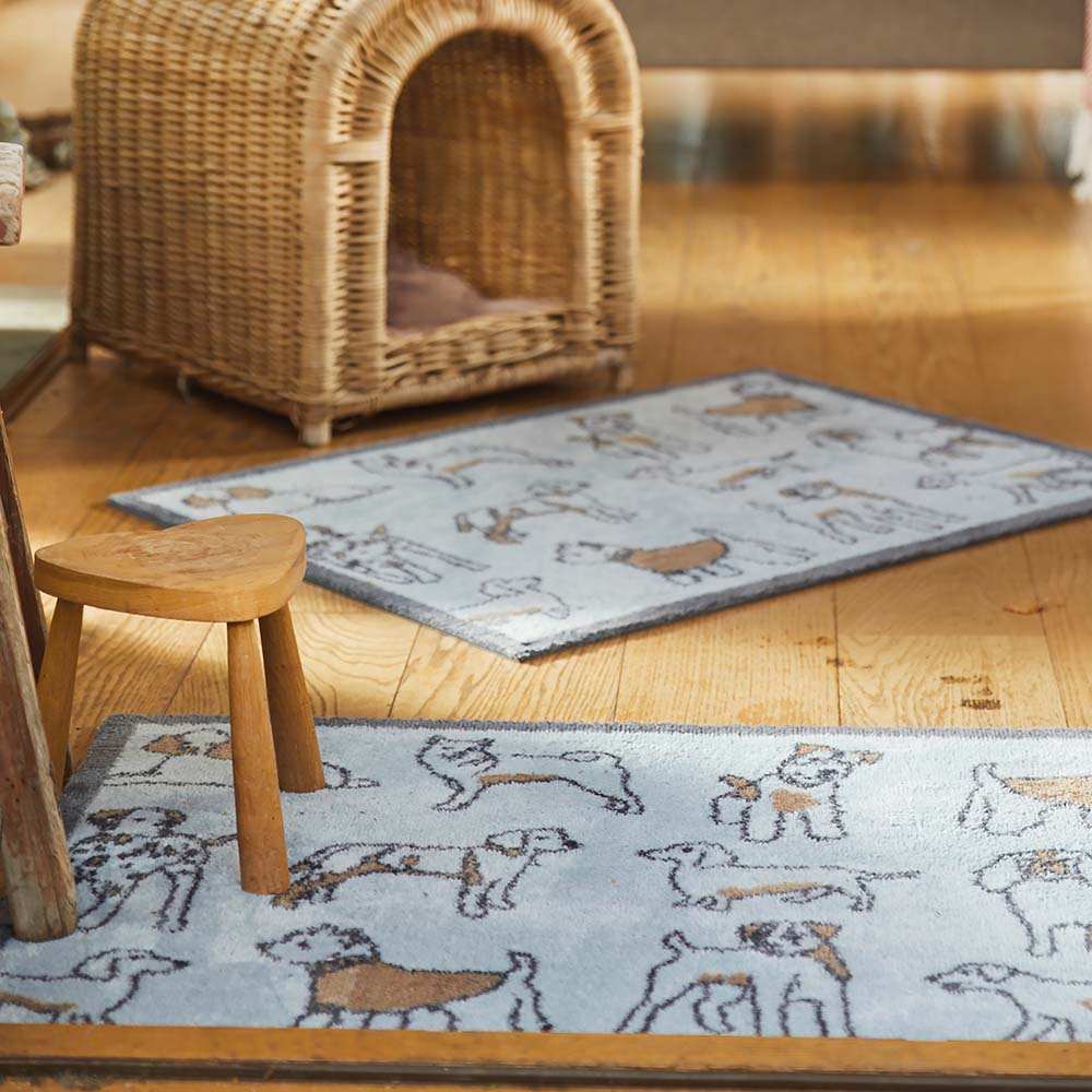 Lifestyle image of a blue Pet 75 washable doormat and washable runner from Hug Rug in living room