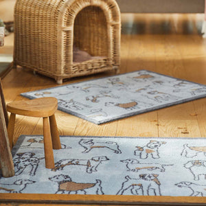 Lifestyle image of a blue Pet 75 washable doormat and washable runner from Hug Rug in living room
