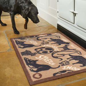 Lifestyle image of a dog and a beige battersea dogs washable kitchen mat