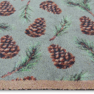 Pinecones Washable runner- 100% recycled cotton runner featuring scattered brown pinecones and green fern leaves.