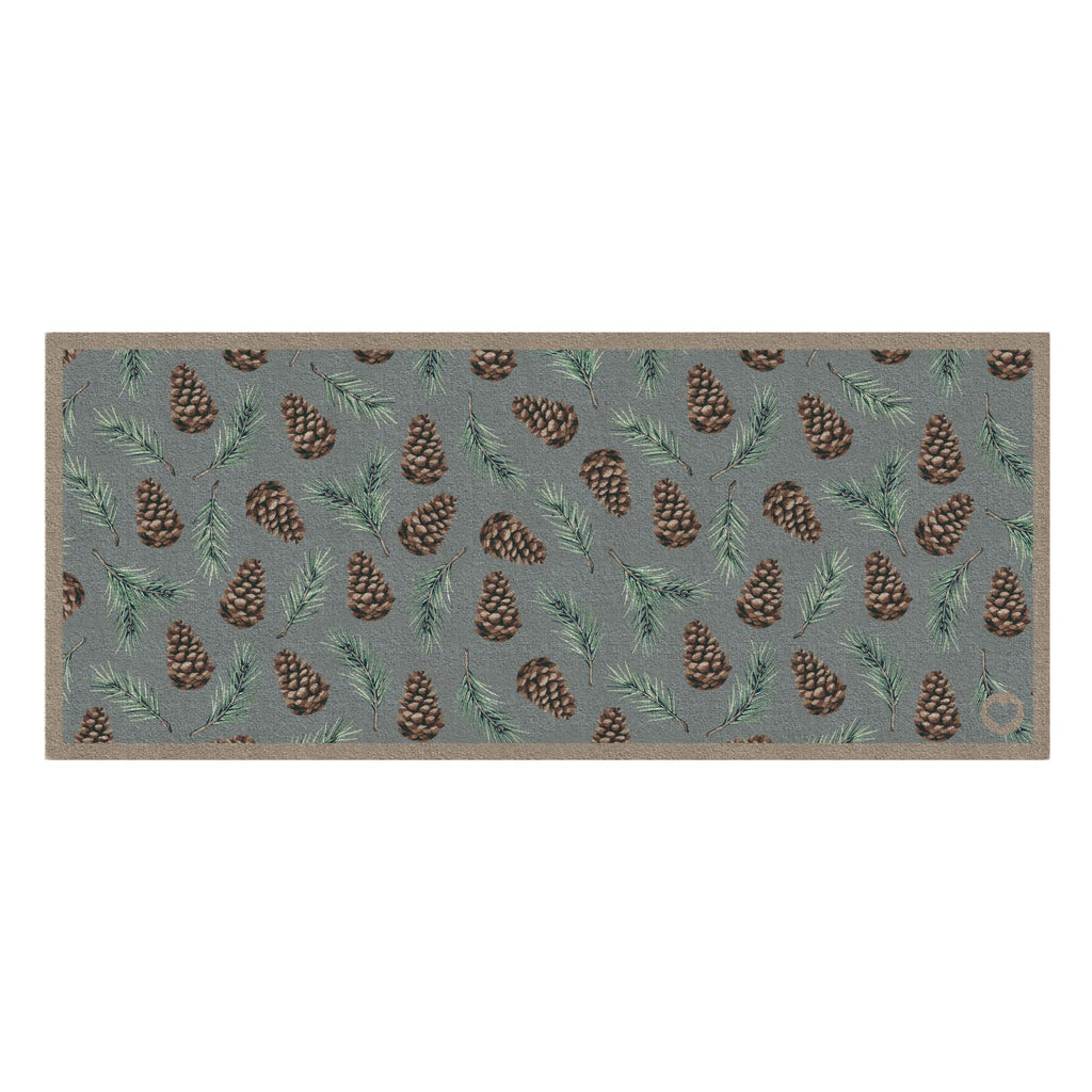 Pinecones Washable runner- 100% recycled cotton runner featuring scattered brown pinecones and green fern leaves.