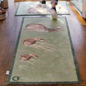 Rabbit 1 Green Washable Runner in Green- a 100% recycled cotton runner featuring three rabbits sitting in the green reeds.