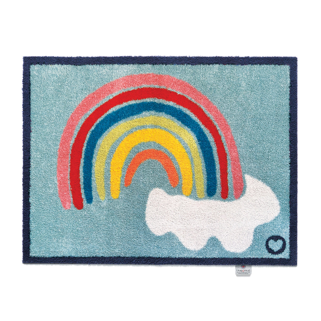 Rainbow 2 Charity Doormat- a 100% cotton doormat in sky blue featuring a rainbow and clouds design.