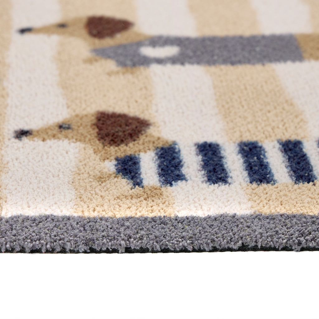 Sausage Dog Chic Washable Runner- 100% recycled cotton runner featuring sausage dogs in jumpers against a beige and cream striped background.
