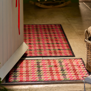 Designer 27 Washable Runner- a 100% cotton runner featuring a vertical houndstooth pattern in shades of pink, red, green, and dark navy.