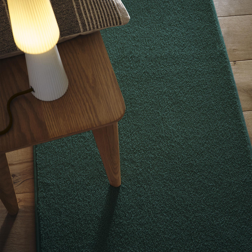 Sense Forest Green Washable Rug Runner- a 100% recycled polyester rug runner in a solid green colour.